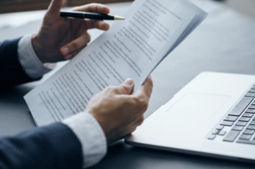 financial reports for small business year-end man reviewing document